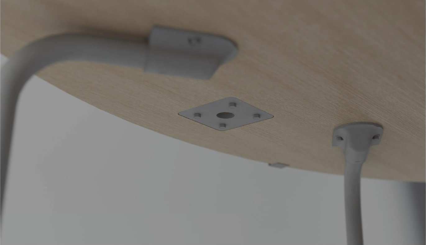 Underside view showing die-cast steel bracket connecting leg to tabletop