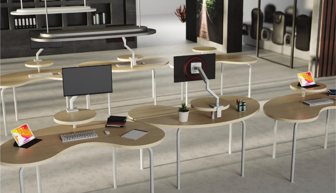 Multiple Kidney Desks arranged in an open-plan office with monitor arms and personal items